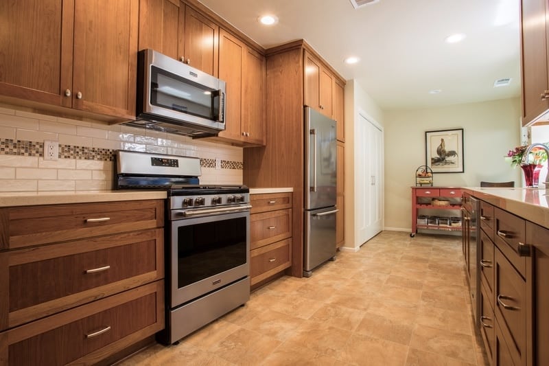 Long view of kitchen with Kraftmaid cabinets in cherry with ginger finish