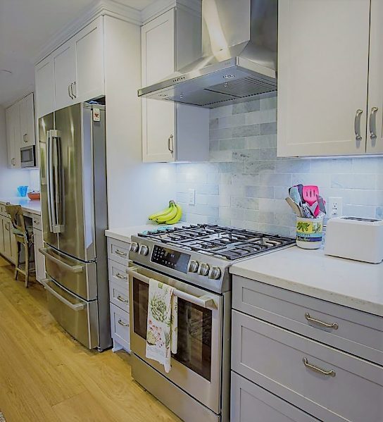 Trendy galley style kitchen with new two toned cabinets