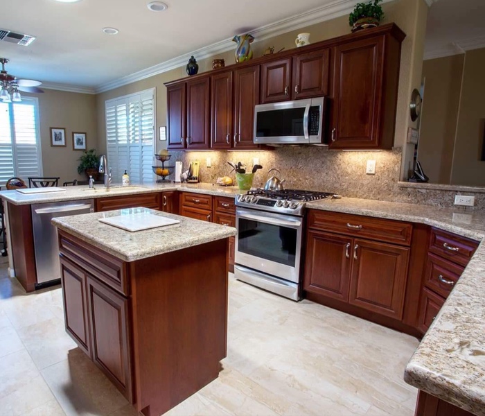 Kitchen with raised panel cabinets in cherry - Leslie Kate photo