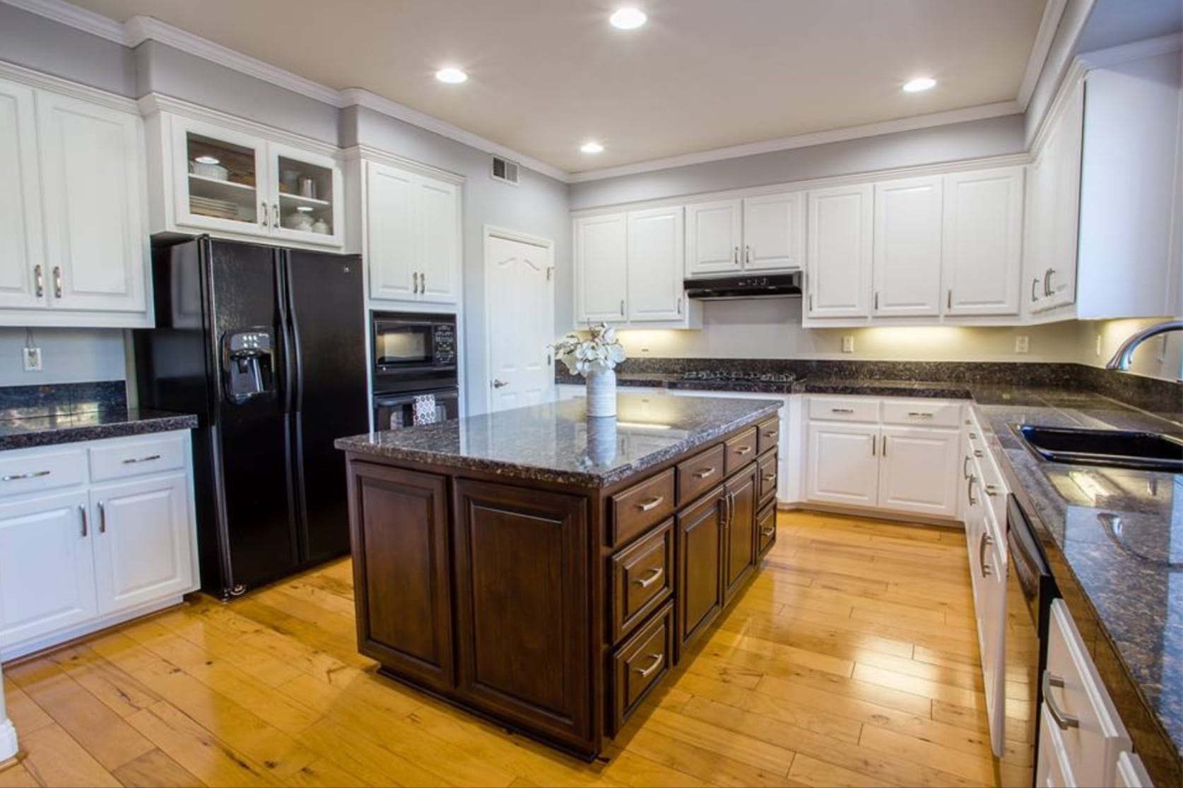 Kitchen after refaced with white thermo-foil